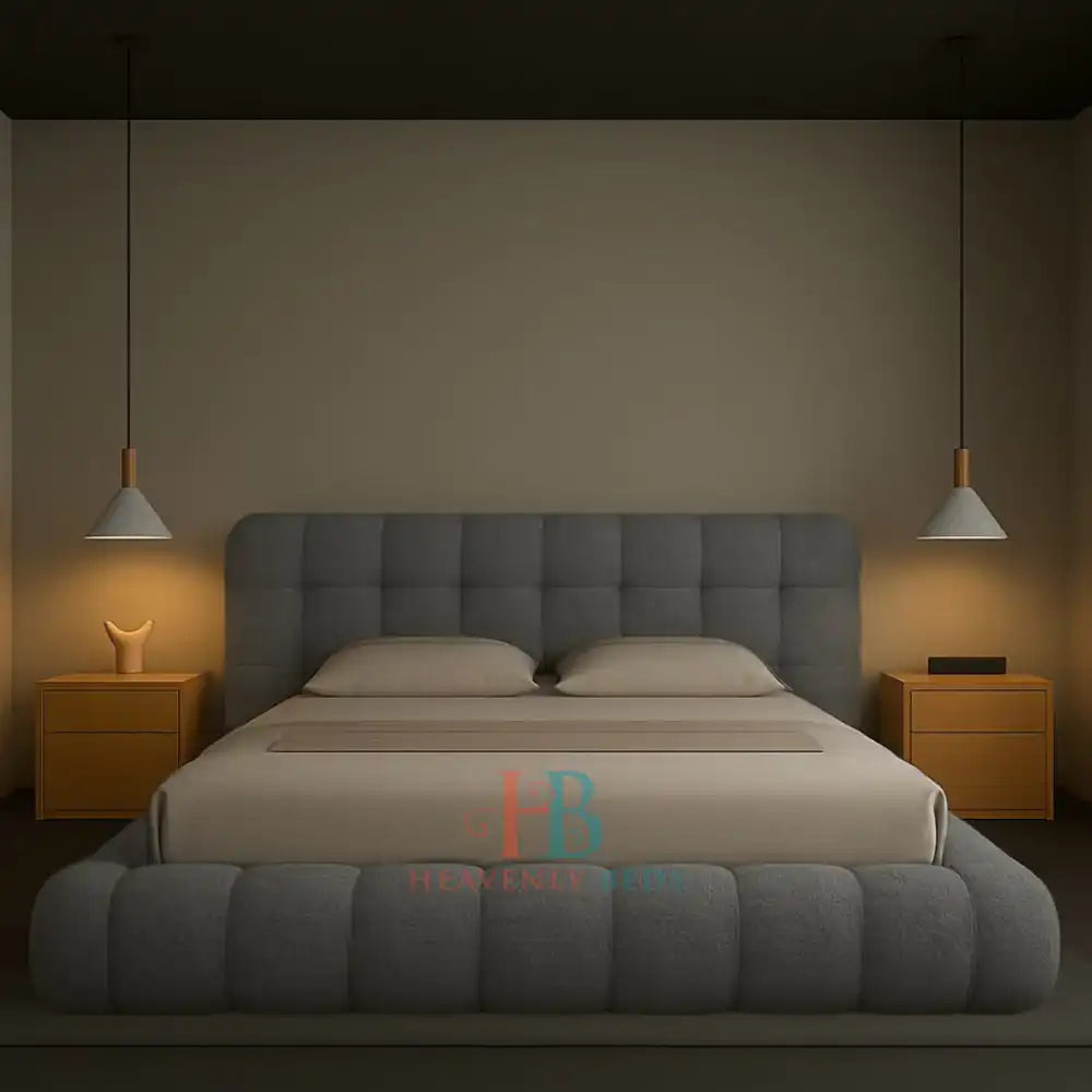Modern grey teddy fabric bubble bed frame with padded headboard and gas lift storage, styled in a minimal bedroom with wooden nightstands and pendant lighting