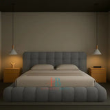 Modern grey teddy fabric bubble bed frame with padded headboard and gas lift storage, styled in a minimal bedroom with wooden nightstands and pendant lighting