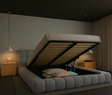 Modern grey teddy fabric bubble bed frame with padded headboard and gas lift storage, styled in a minimal bedroom with wooden nightstands and pendant lighting with metal gas lift open