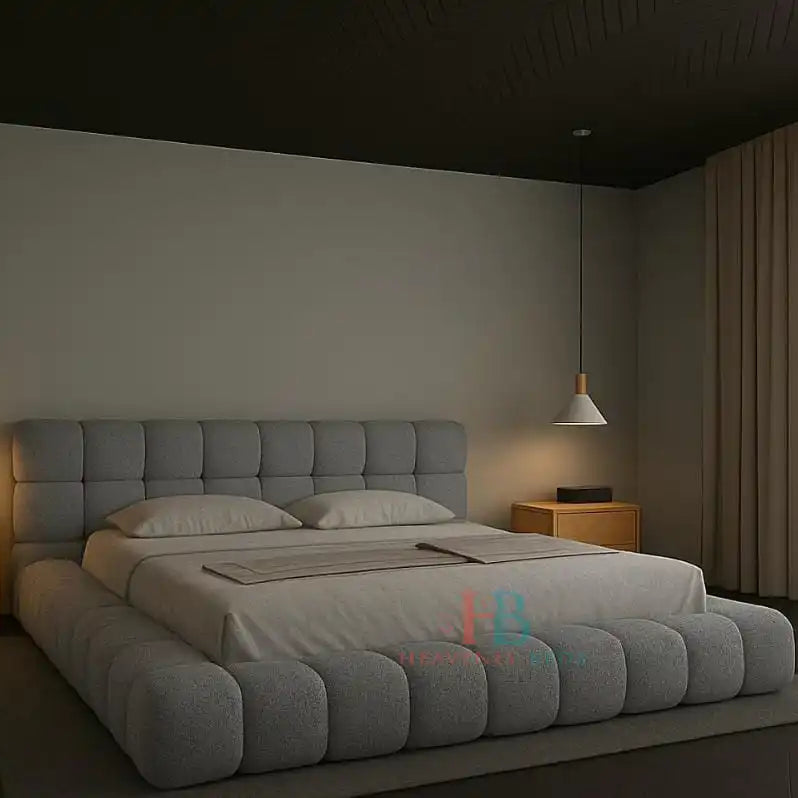 Modern grey teddy fabric bubble bed frame with padded headboard and gas lift storage, styled in a minimal bedroom with wooden nightstands and pendant lighting